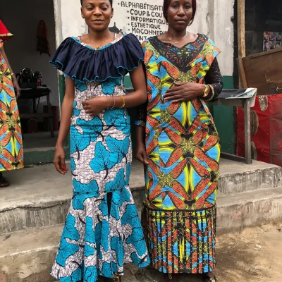 Simera Bolaubande (left) and Alpha Shingatu (right) present their self-sewn dresses in Kingabwa, Kinshasa.